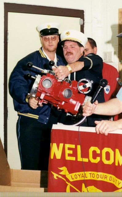 Chief John Chambers receives his gift at the housing at Station 12.  He's not sure what this is? For a hydrant?